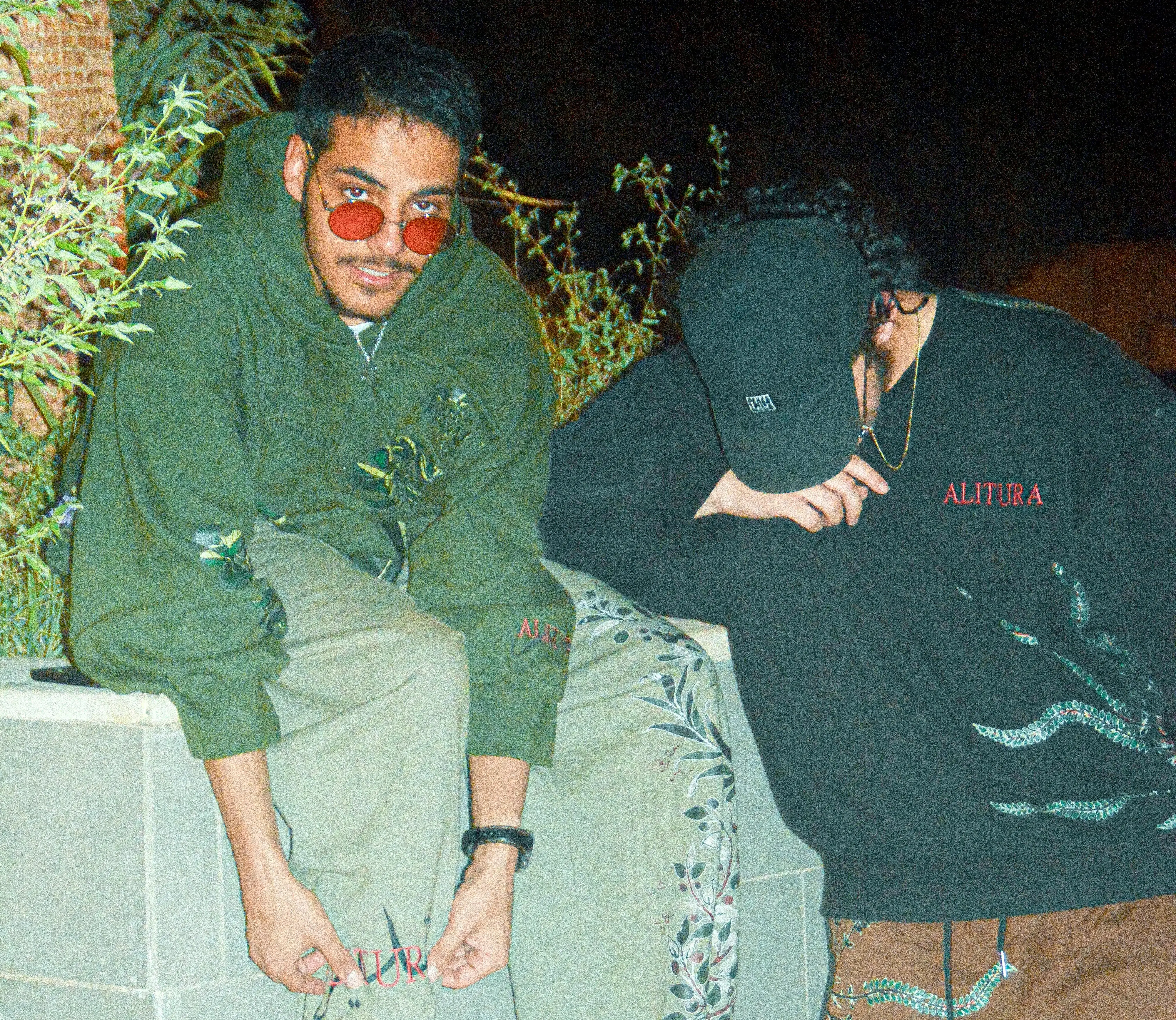 Two people wearing ALITURA garments by the water