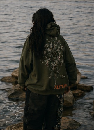 Botanical Hoodie back view by the water